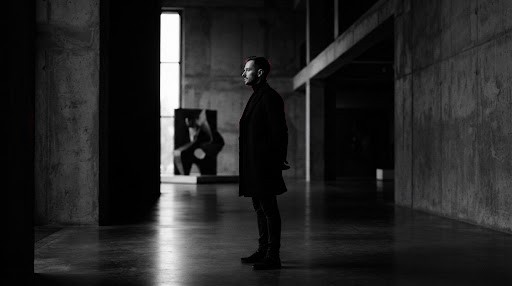Founder in brutalist gallery